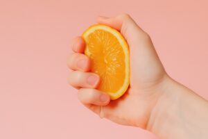 Hand squeezing an orange